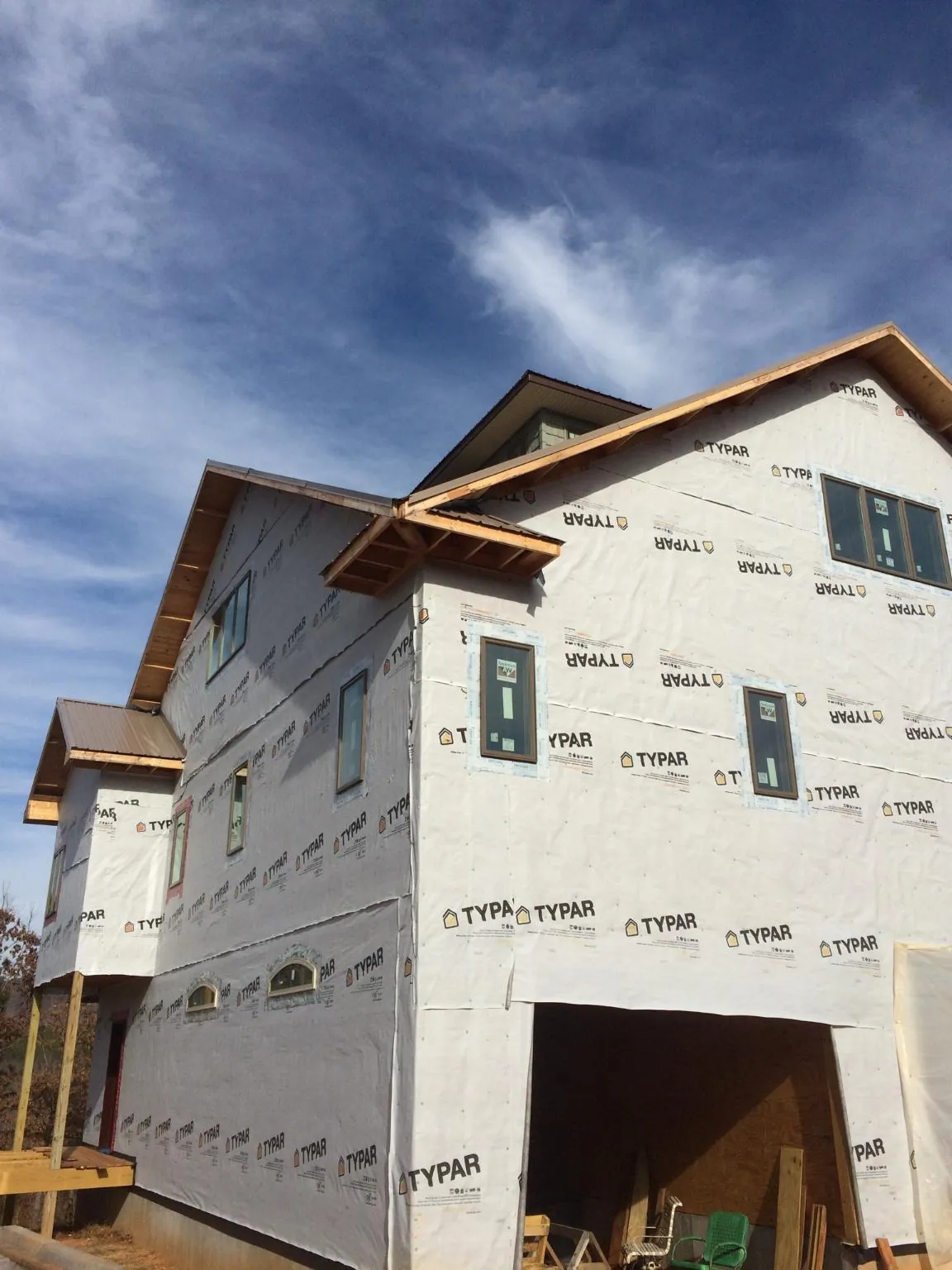 Stick built house wrapped in Typar with new roof framing and dormers in Vashon